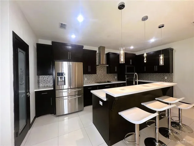 a large kitchen with a table and chairs