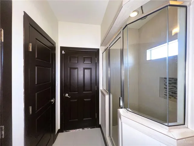 a bathroom with a shower and a sink