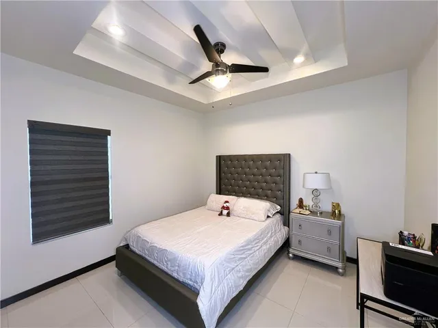 a bedroom with a bed and a ceiling fan