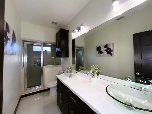 a bathroom with a double vanity sink and a mirror