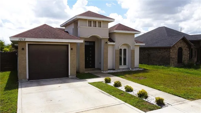 a front view of a house with garden