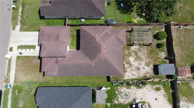 an aerial view of multiple houses with yard