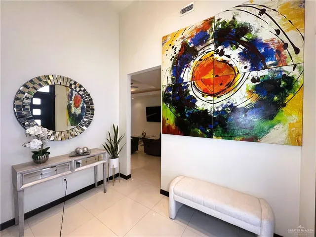 wooden floor with a stove and a view of bedroom