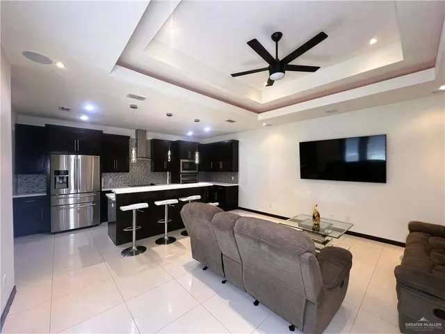 a living room with furniture a ceiling fan and a window