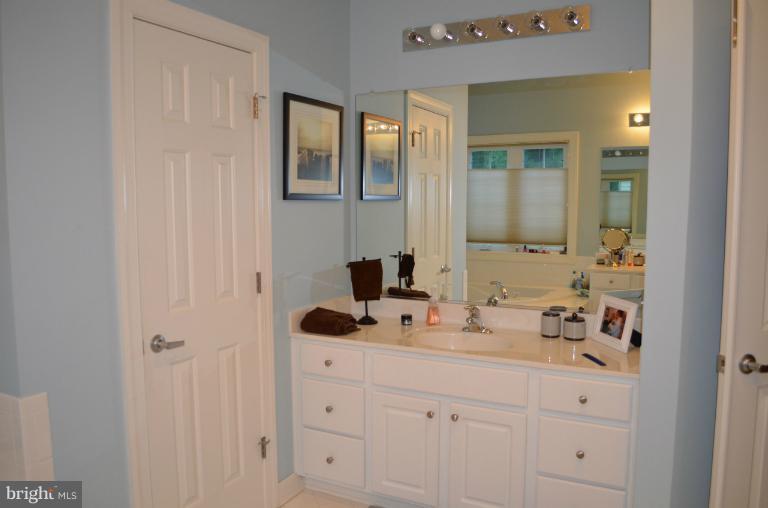 10850 Nemrod Road Perry Hall, MD 21128 - Photo 4 of 25 a bathroom with cabinets sink and mirror