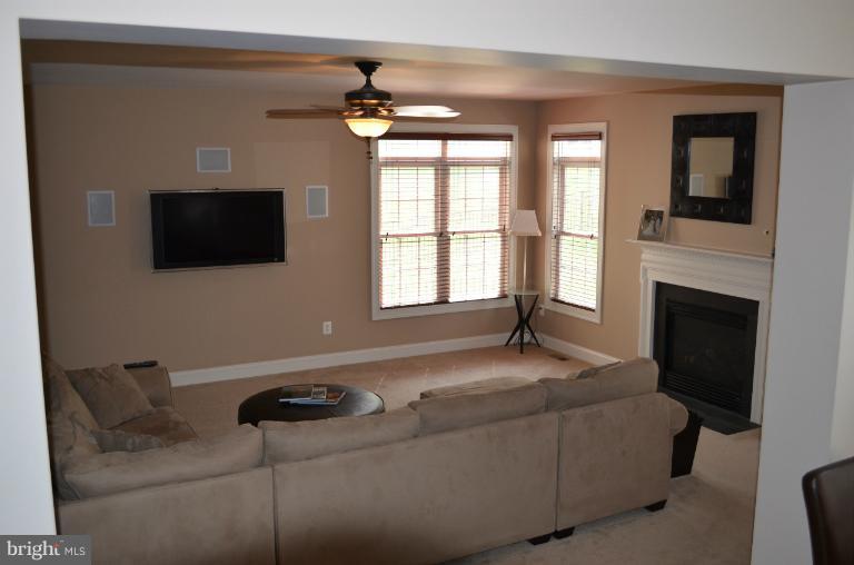10850 Nemrod Road Perry Hall, MD 21128 - Photo 9 of 25 a living room with furniture a flat screen tv and a fireplace