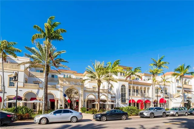 a building exterior with palm trees