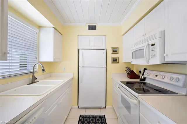 a kitchen with a sink a refrigerator a stove a washer and dryer