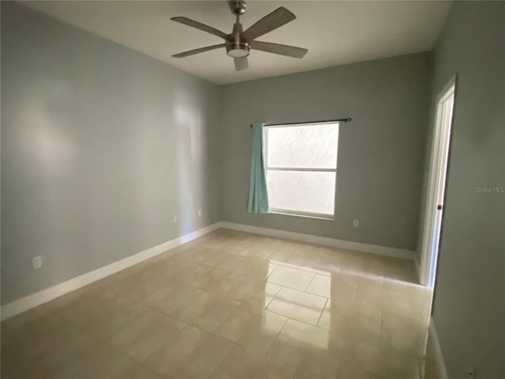 2467 Huron Circle Kissimmee, FL 34746 - Photo 11 of 26 an empty room with windows and fan