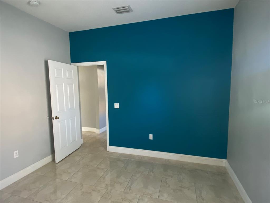 2467 Huron Circle Kissimmee, FL 34746 - Photo 14 of 26 an empty room with closet and mirror