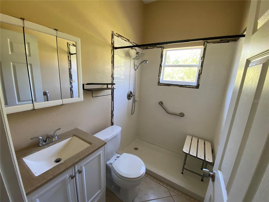 2467 Huron Circle Kissimmee, FL 34746 - Photo 23 of 26 a bathroom with a sink toilet and shower