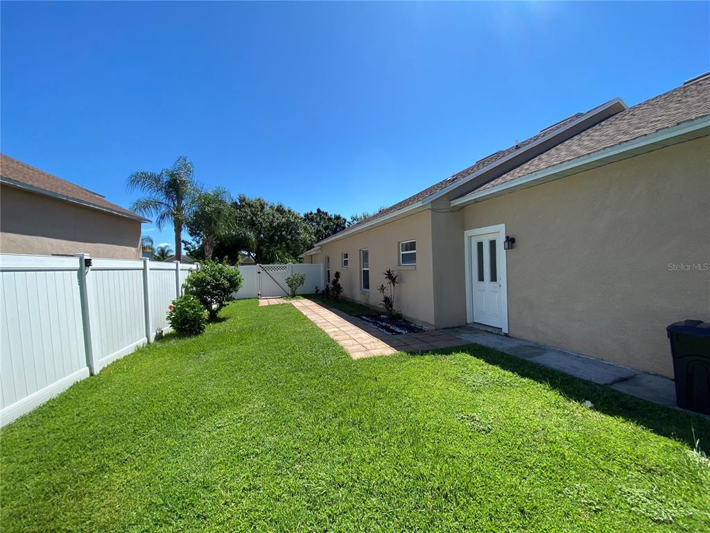 2467 Huron Circle Kissimmee, FL 34746 - Photo 25 of 26 a view of backyard with potted plants and wooden fence