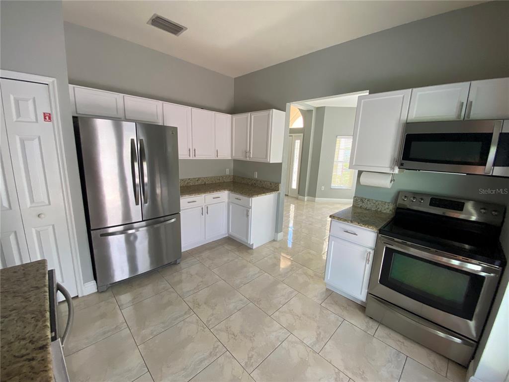 2467 Huron Circle Kissimmee, FL 34746 - Photo 5 of 26 a kitchen with a refrigerator sink and microwave