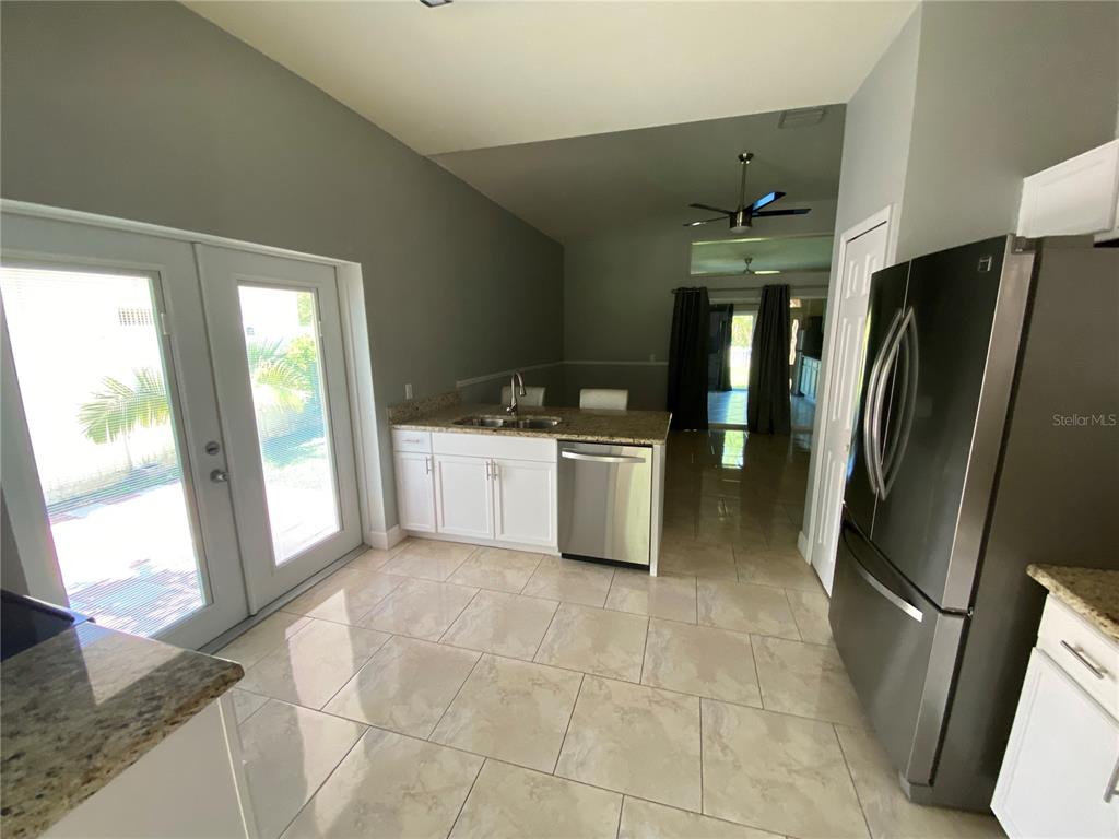 2467 Huron Circle Kissimmee, FL 34746 - Photo 6 of 26 a kitchen with stainless steel appliances a refrigerator sink and microwave