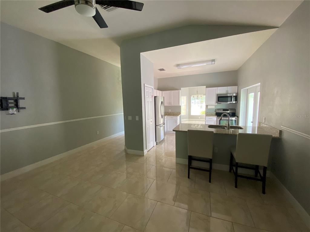 2467 Huron Circle Kissimmee, FL 34746 - Photo 10 of 26 a view of kitchen with furniture and a refrigerator