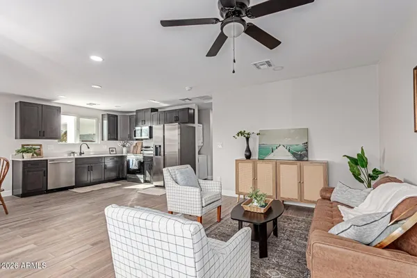 a living room with furniture and kitchen view