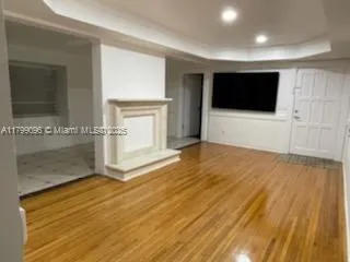 a view of a livingroom with an empty space and a fireplace
