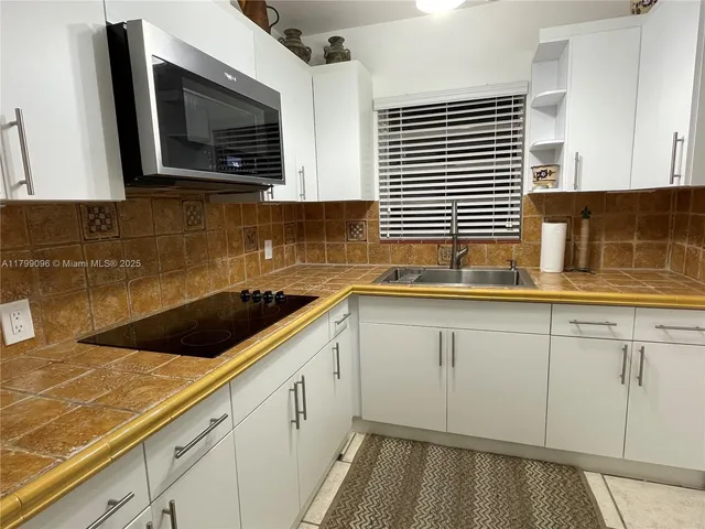 a kitchen with a sink and cabinets
