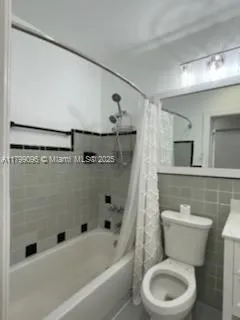 a bathroom with a toilet a sink and bathtub