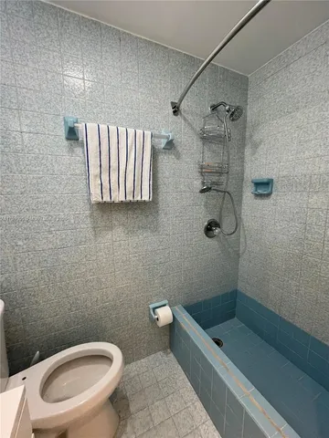 a bathroom with a toilet a sink and shower