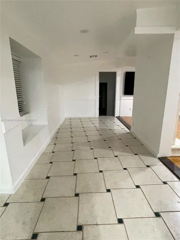 a view of an empty room with windows