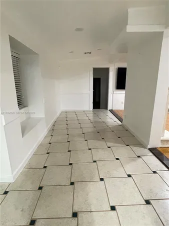 a view of an empty room with windows