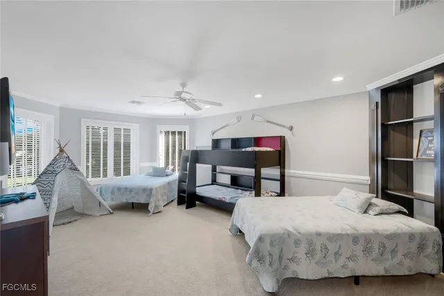 a bedroom with a bed and large windows