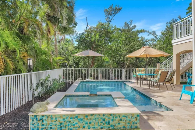 swimming pool view with a seating space