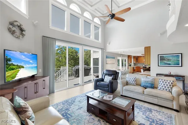 a living room with furniture and a view of kitchen