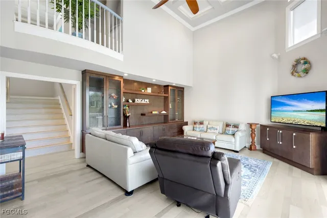 a kitchen with stainless steel appliances kitchen island granite countertop a table chairs sink and wooden cabinets