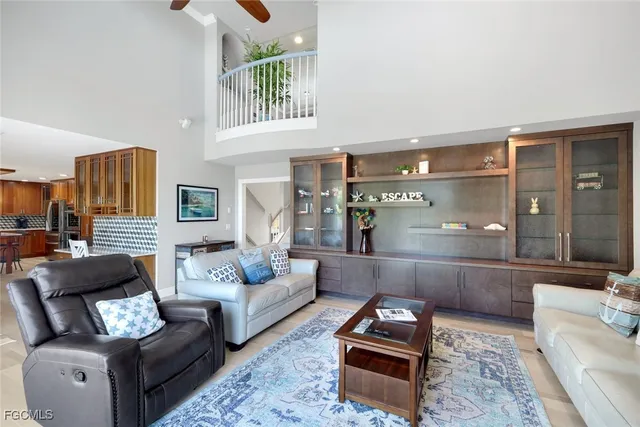a living room with furniture and a view of kitchen