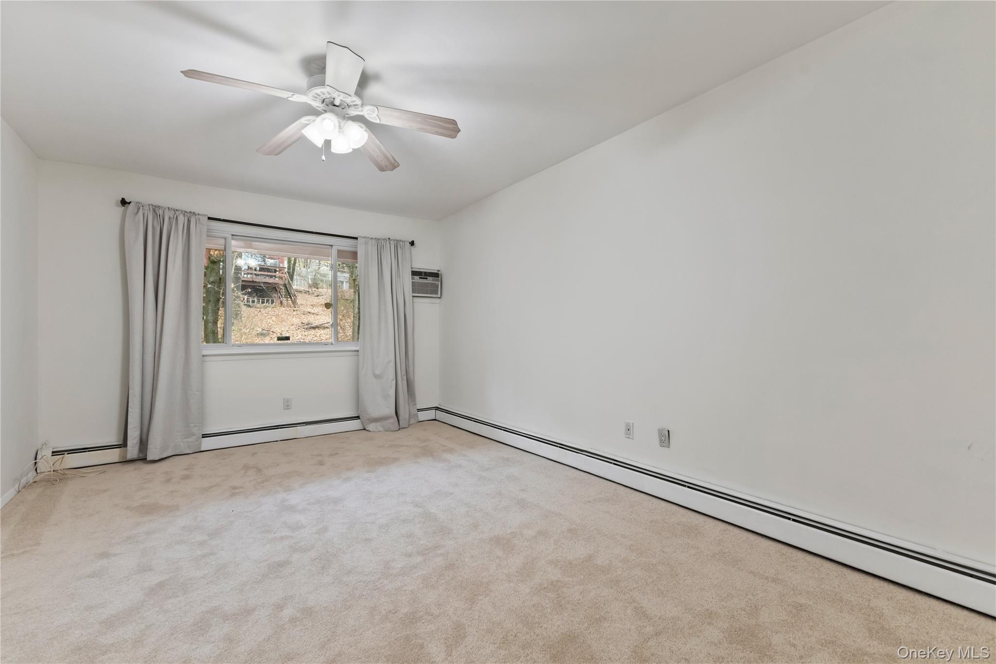 8 North James Street, Unit G Peekskill, NY 10566 - Photo 14 of 25 an empty room with windows and fan