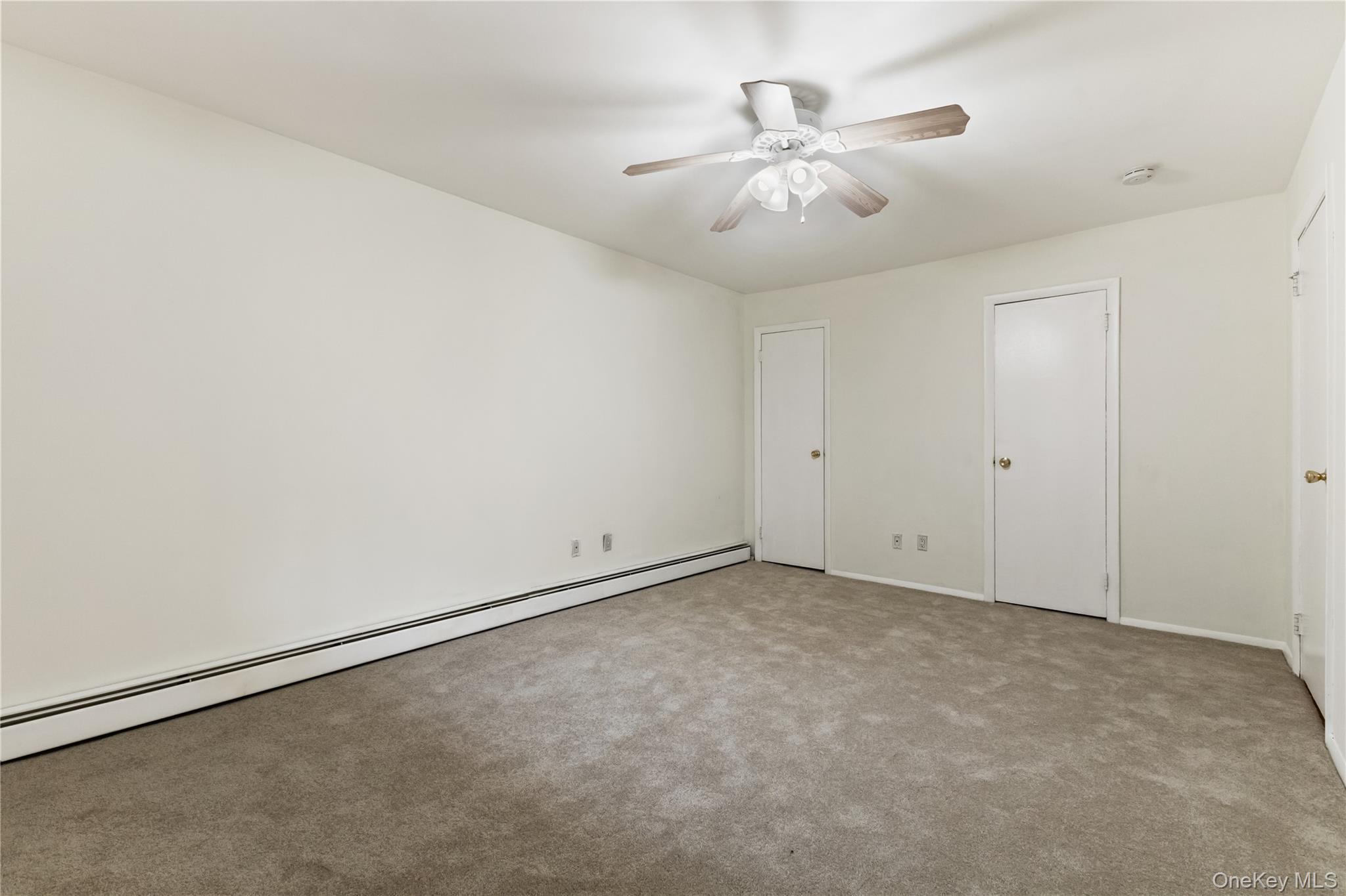 8 North James Street, Unit G Peekskill, NY 10566 - Photo 16 of 25 an empty room with chandelier fan and window