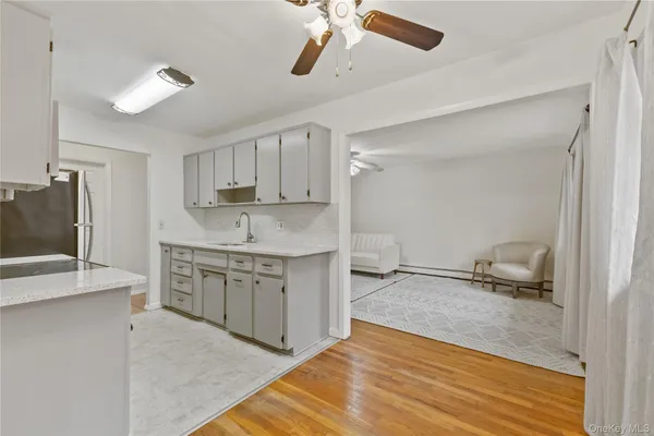 a kitchen with granite countertop a sink appliances and cabinets