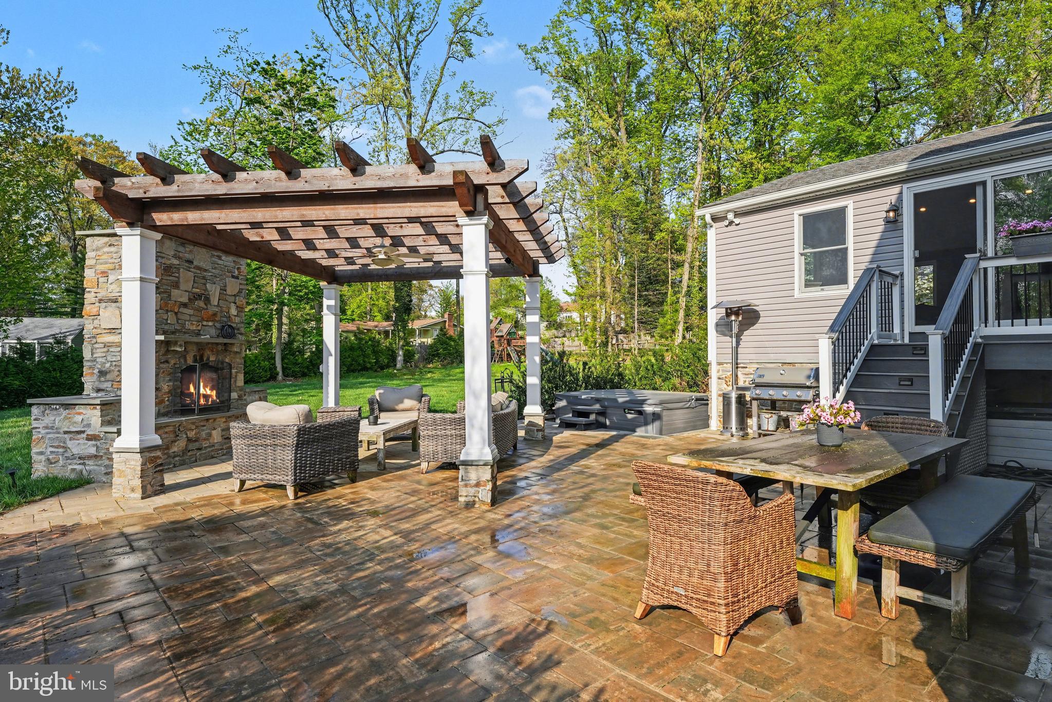 443 Woodcrest Road Wayne, PA 19087 - Photo 47 of 63 a view of a patio with table and chairs potted plants with wooden floor and fence