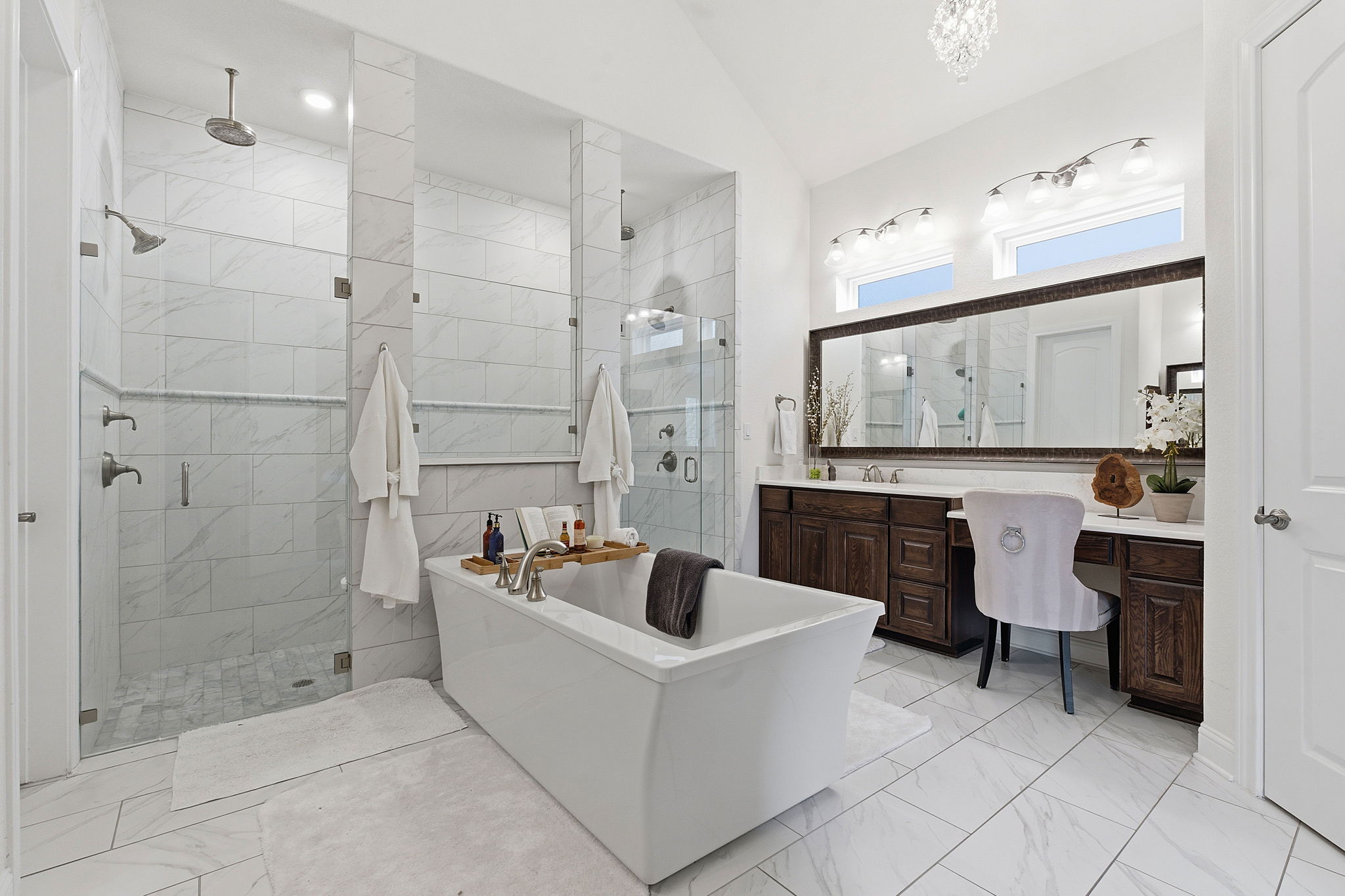 2824 Wedgescale Pass Leander, TX 78641 - Photo 21 of 40 Spa-inspired primary bathroom boasts a dual vanity, comfort-height countertop, frameless walk-in shower, dual rain showerheads and floor-to-ceiling tile
