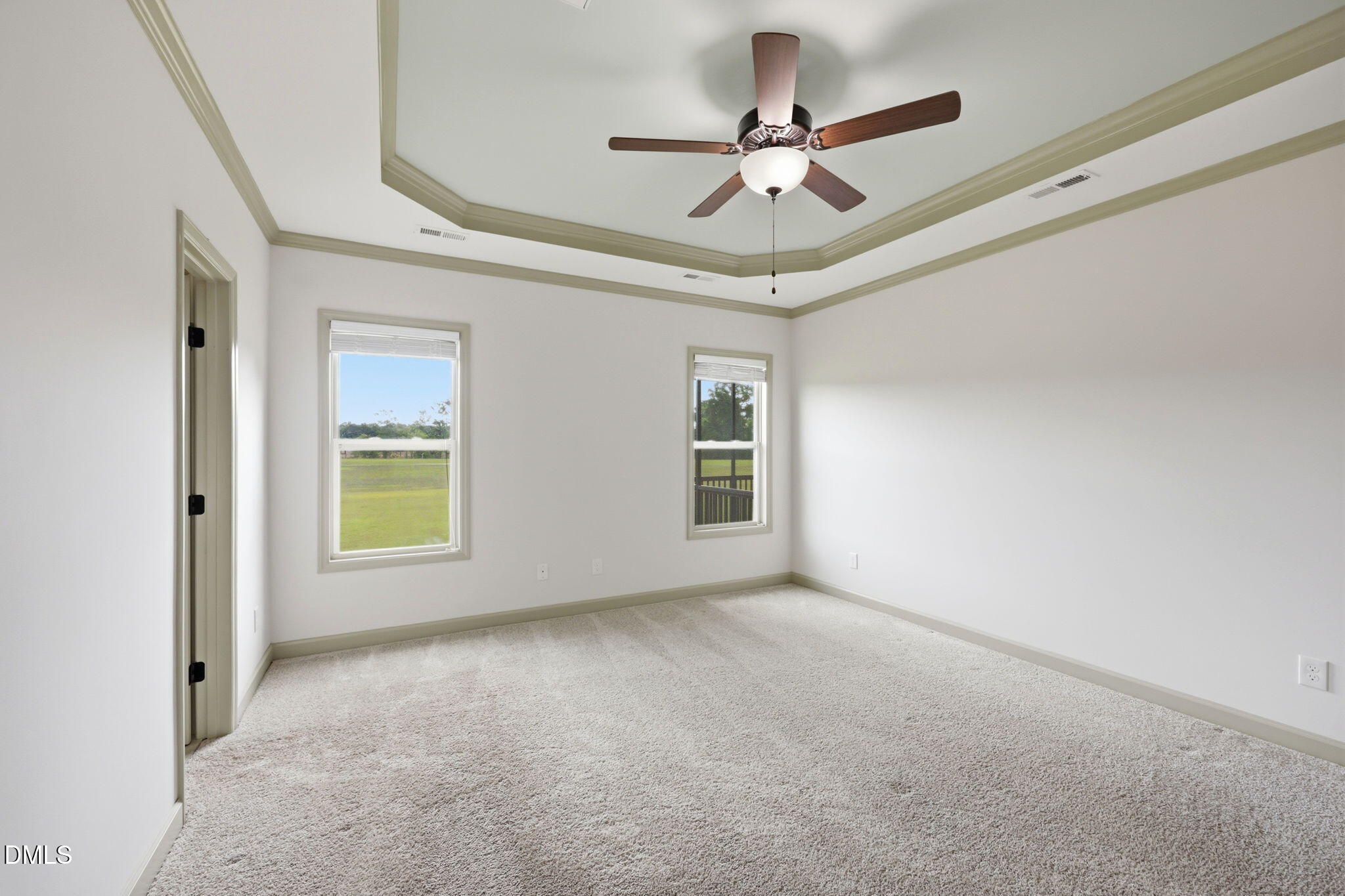 3587 Hannah Creek Road Benson, NC 27504 - Photo 16 of 43 an empty room with a ceiling fan and windows