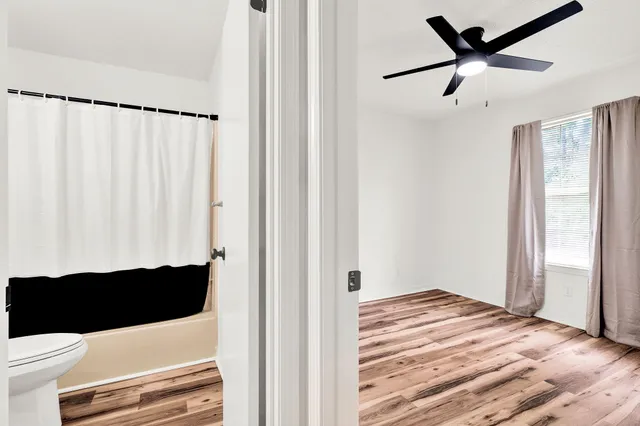 a view of empty room with wooden floor