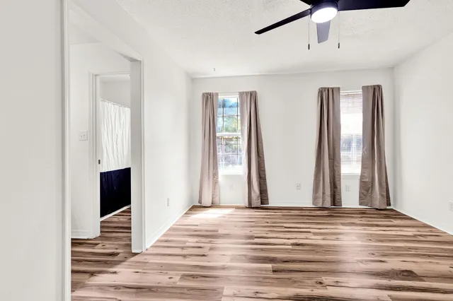 a view of a livingroom with wooden floor and window