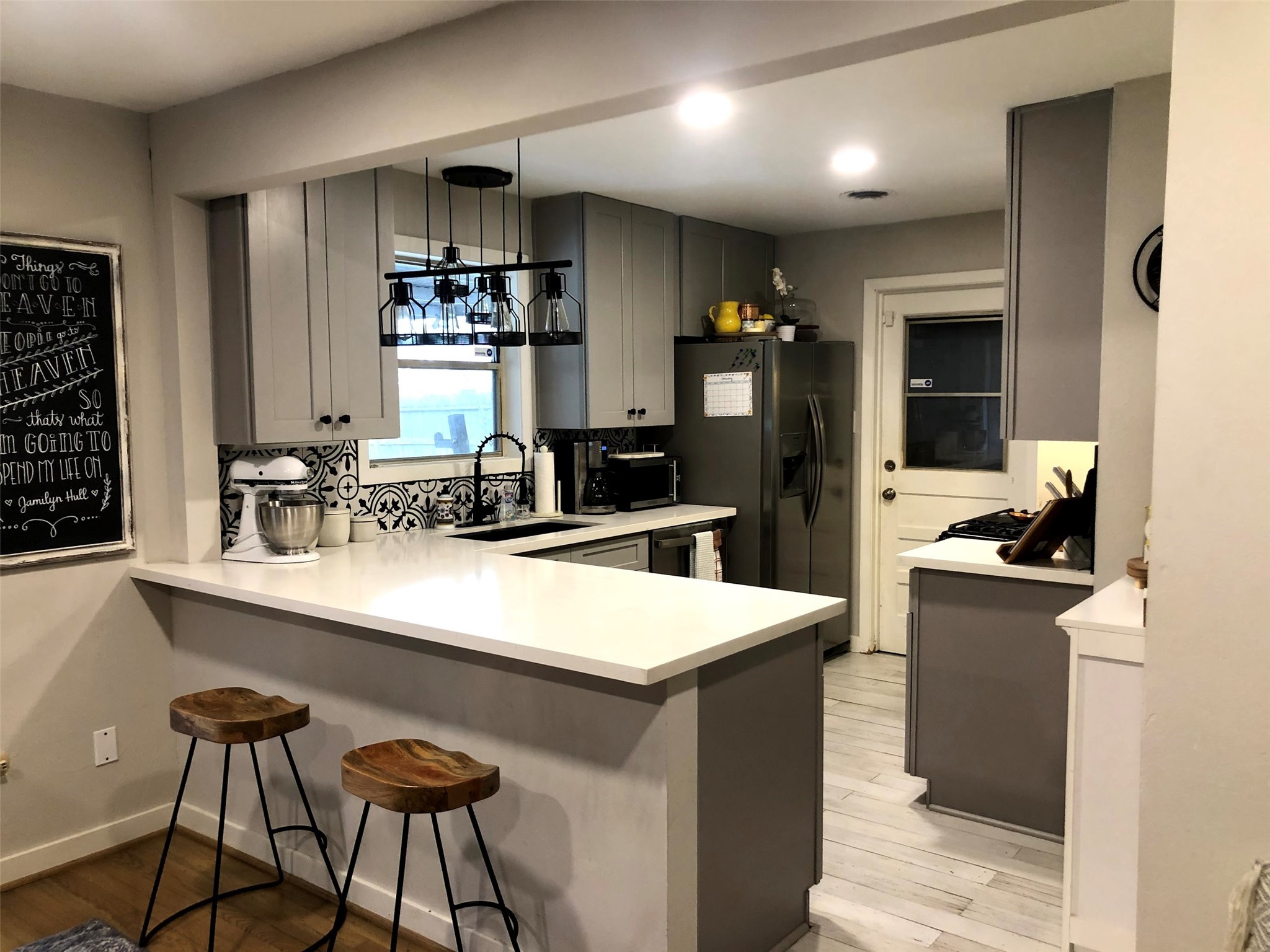 a kitchen with a sink a stove and chairs