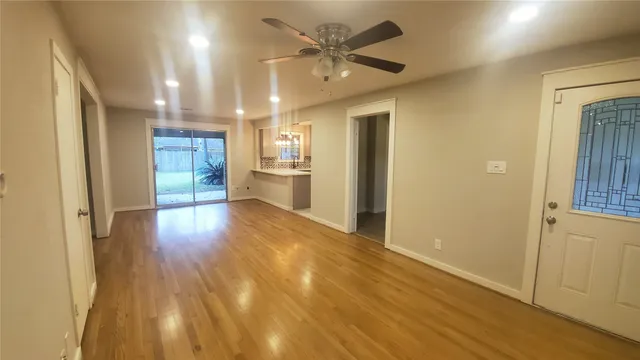 a view of a hallway with wooden floor