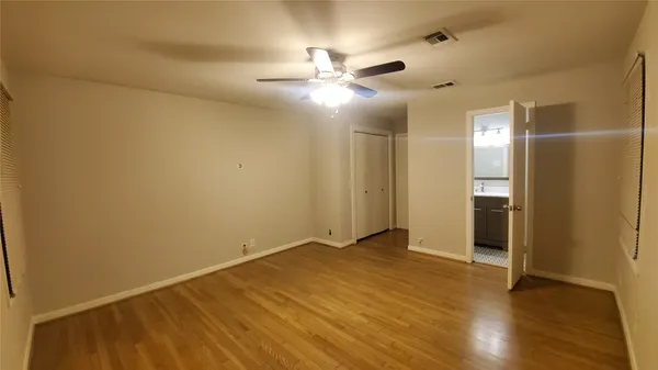 a view of an empty room with a ceiling fan