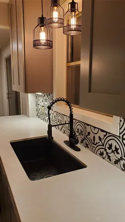 a kitchen with a refrigerator and a sink