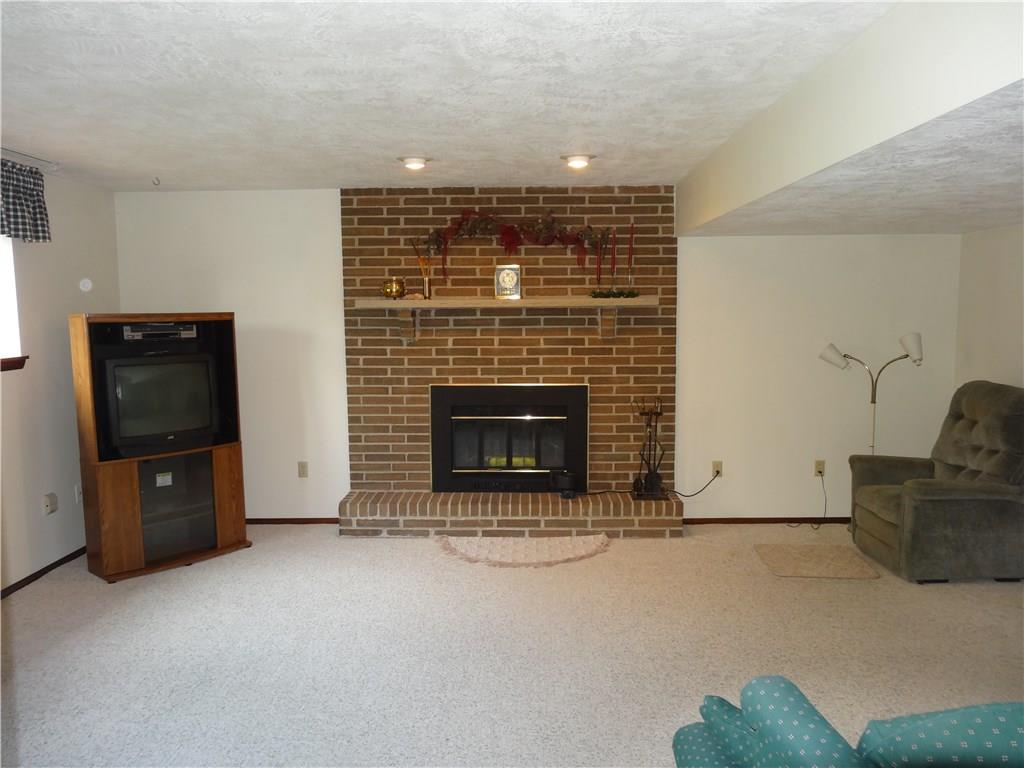4017 Willett Road Pittsburgh, PA 15227 - Photo 11 of 17 Large finished basement with log burning fireplace.