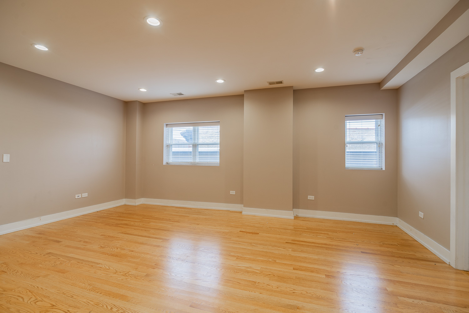 3433 South Indiana Avenue, Unit 301 Chicago, IL 60616 - Photo 5 of 12 a view of an empty room with wooden floor and a window