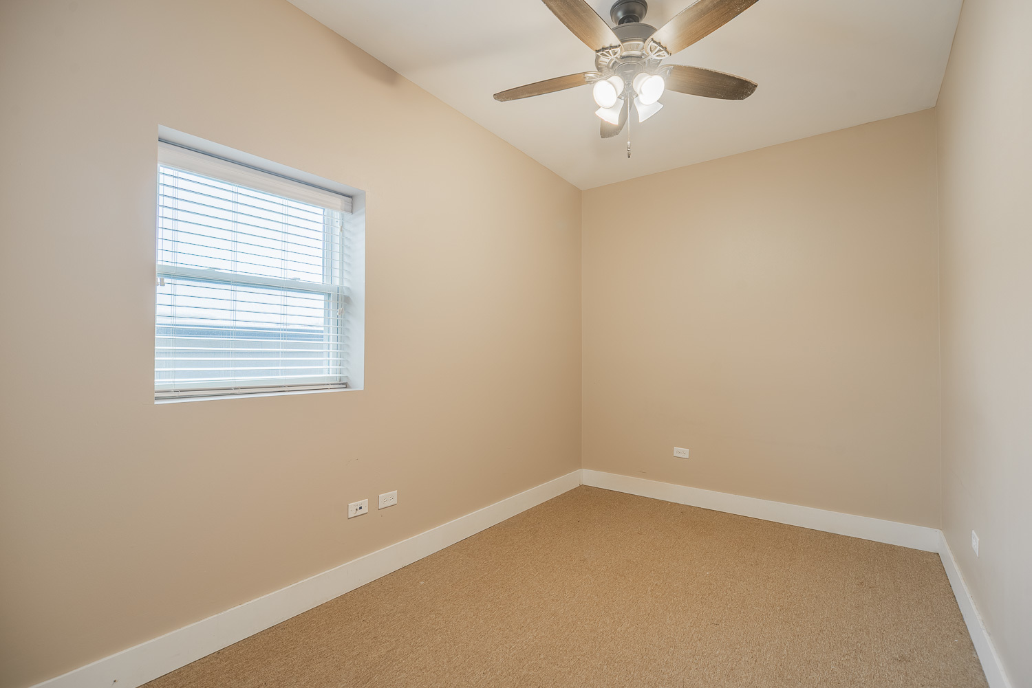 3433 South Indiana Avenue, Unit 301 Chicago, IL 60616 - Photo 9 of 12 an empty room with a window and a fan