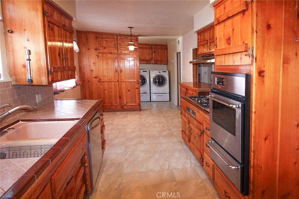 17832 Lemarsh Street Northridge, CA 91325 - Photo 11 of 14 a kitchen with granite countertop a refrigerator and a sink