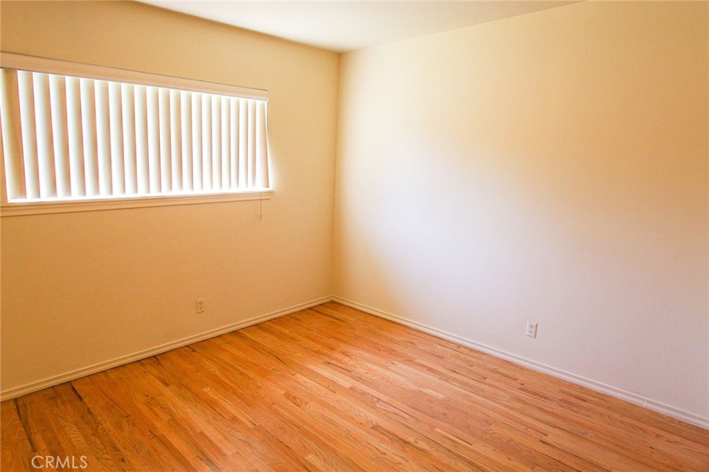 17832 Lemarsh Street Northridge, CA 91325 - Photo 13 of 14 an empty room with wooden floor and windows