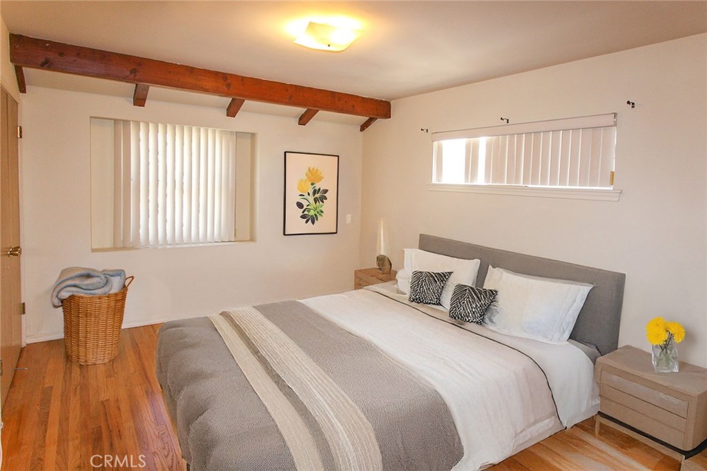 17832 Lemarsh Street Northridge, CA 91325 - Photo 3 of 14 a bedroom with a bed and wooden floor