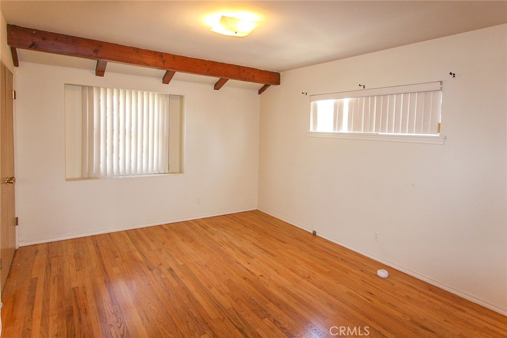 17832 Lemarsh Street Northridge, CA 91325 - Photo 5 of 14 a view of empty room with wooden floor and fan